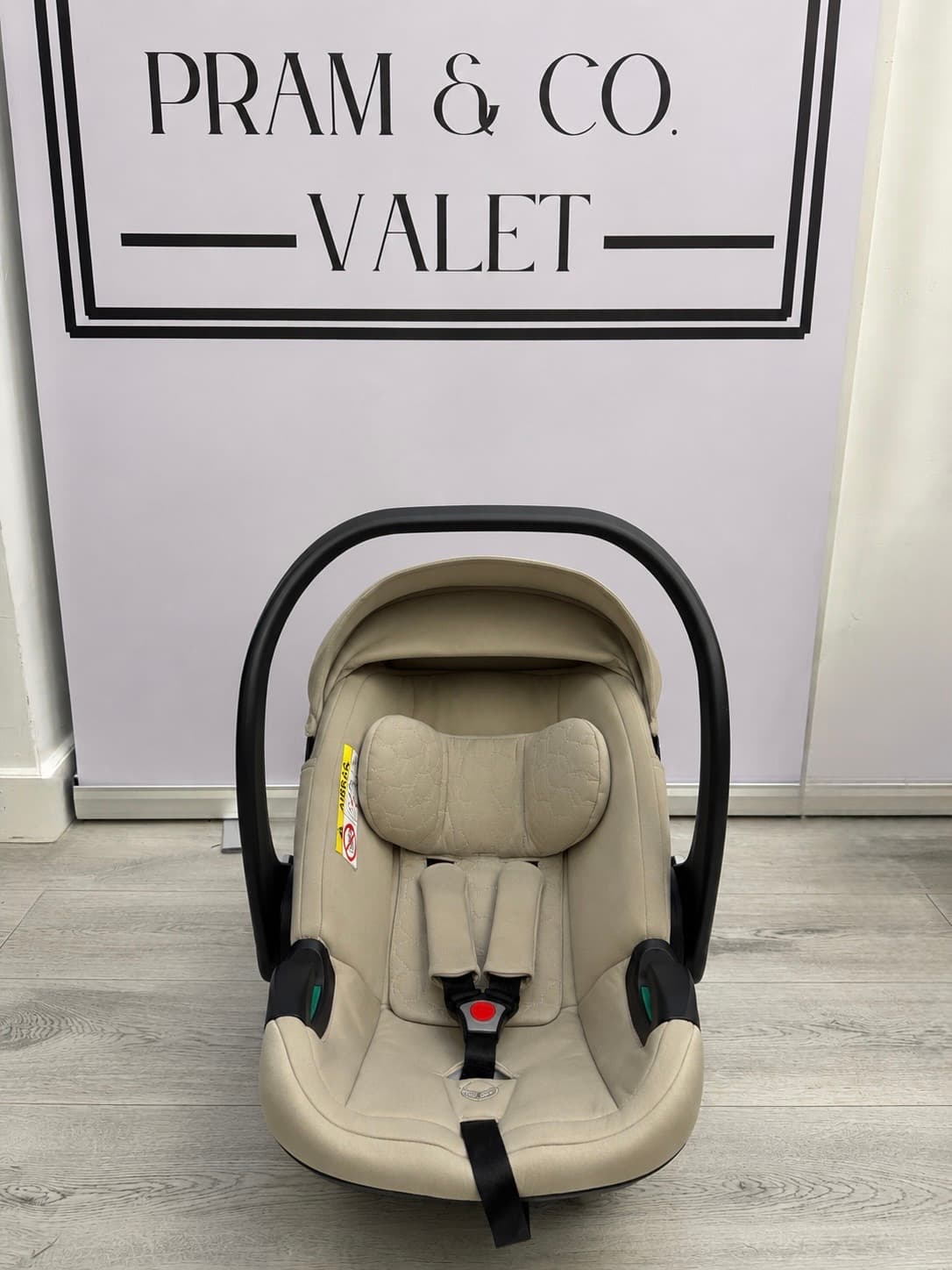 After cleaning, the Egg car seat fabric and harness area looking refreshed.