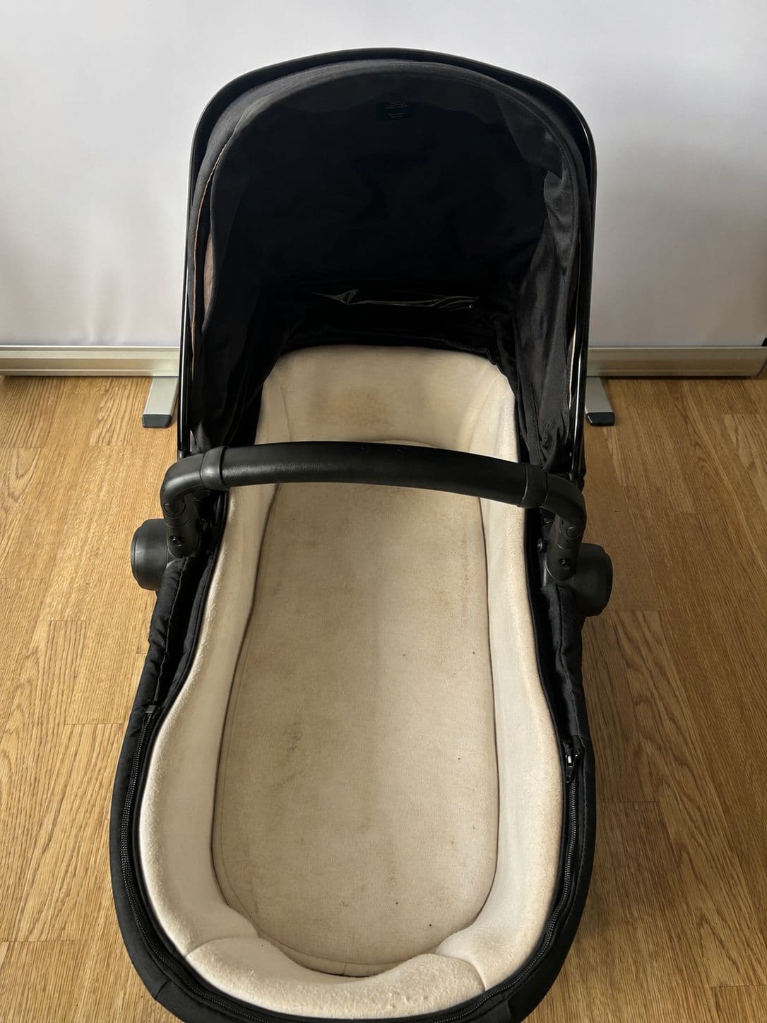 Before cleaning, a Silver Cross bassinet with marked fabric and lining.